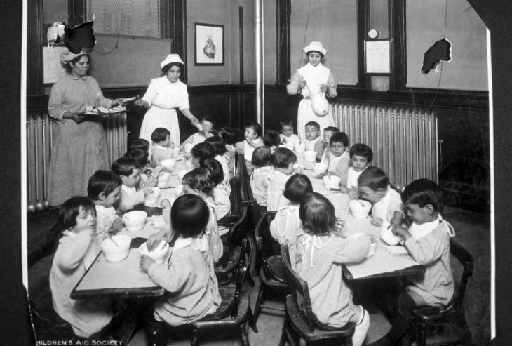 a group of children sitting in a children's aid nursery