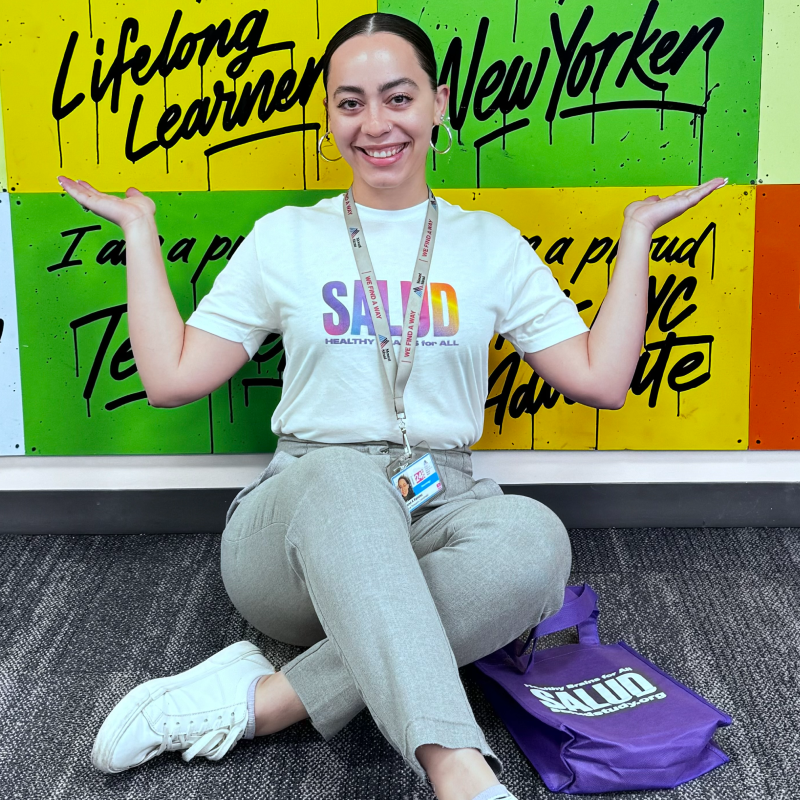 Woman sitting on grand against a colorful background.