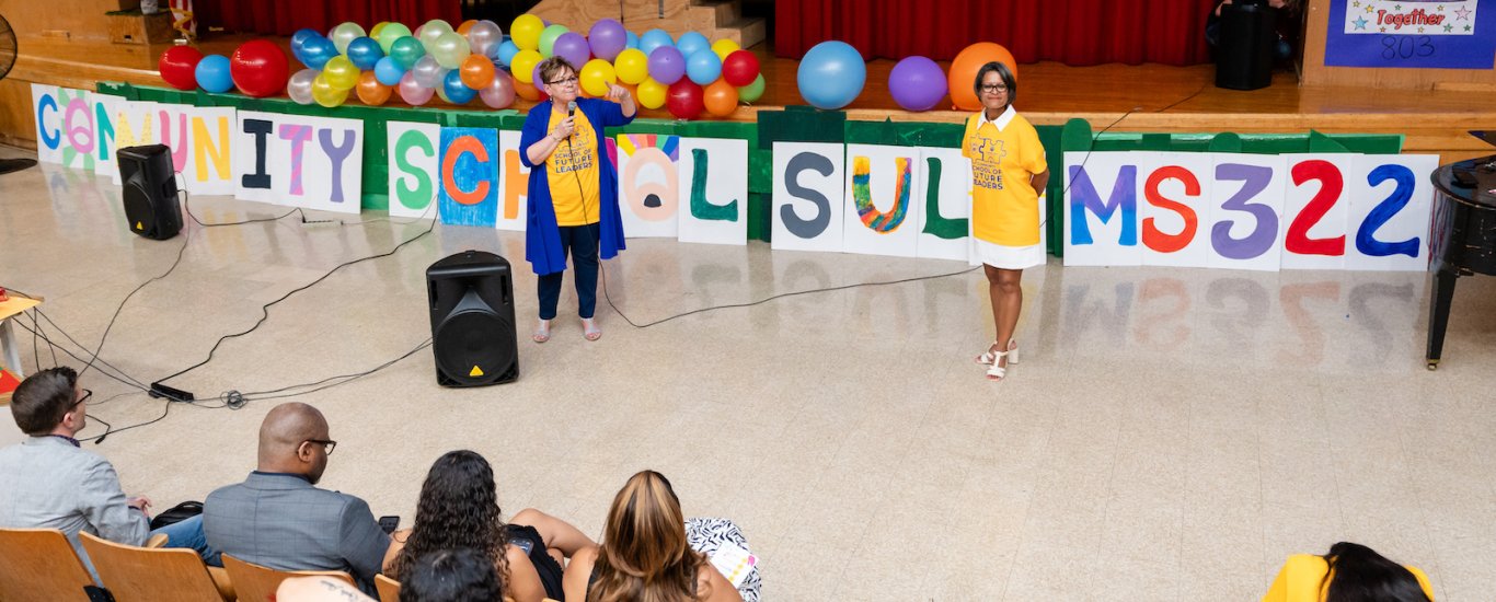 Miriam Rosa and Migdalia Cortes of SULA speaking in auditorium