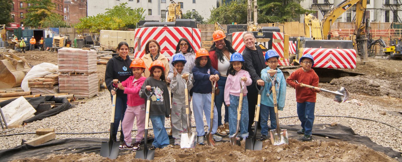 Kids and staff posing for groundbreaking dig