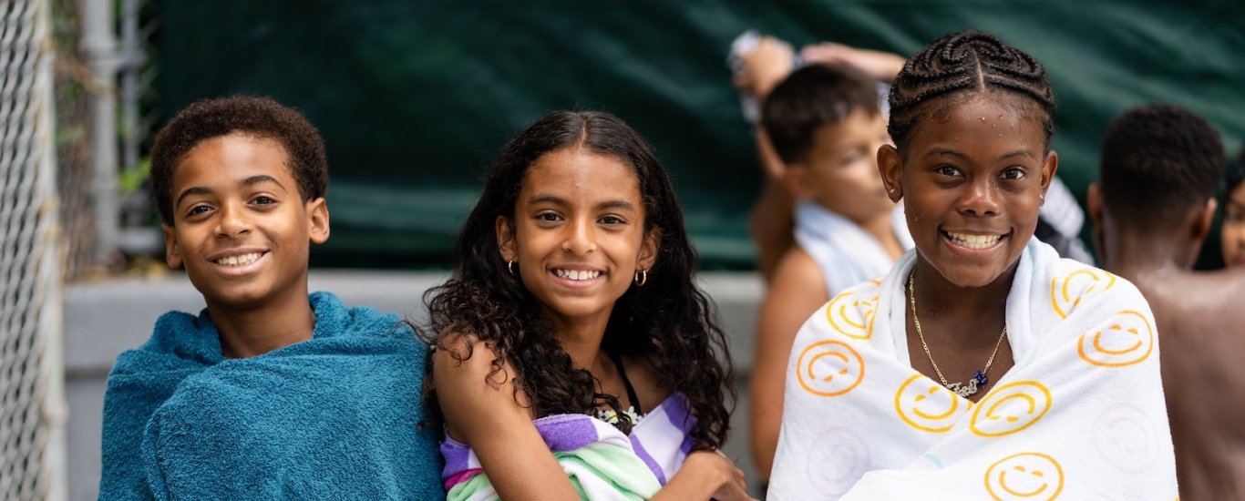 Students wrapped in beach towel. 