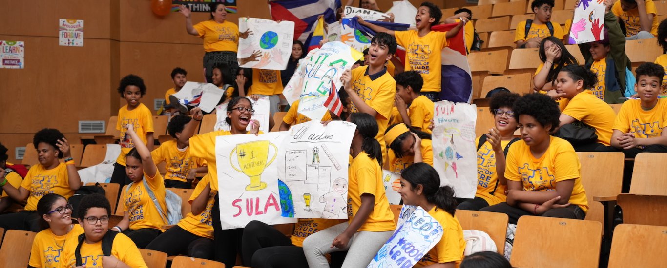 Students celebrating in auditorium