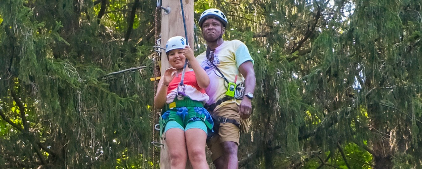 Young girl attempting rope course at Wagon Road Camp