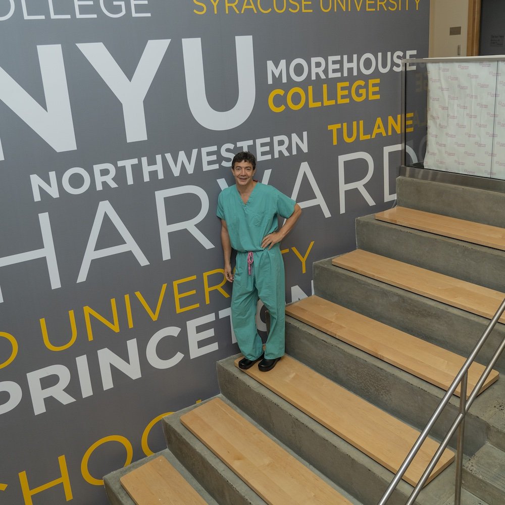Dr. Raja Flores on a staircase