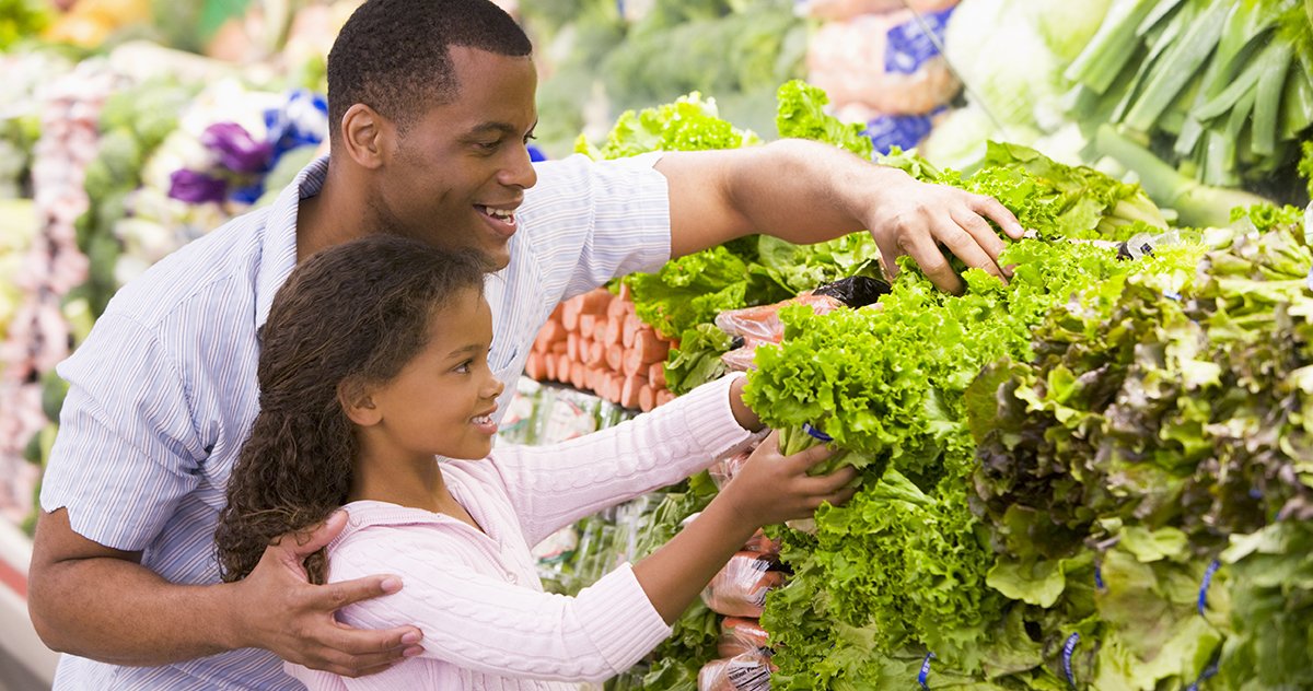 Father and daughter shopping for fruits and vegetables