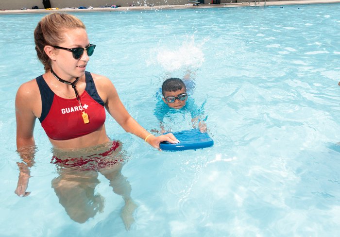 Lifeguard with student swimmer at the Children's Aid Goodhue Pool