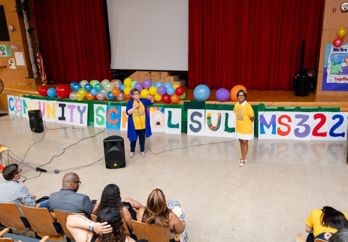 Miriam Rosa and Migdalia Cortes of SULA speaking in auditorium
