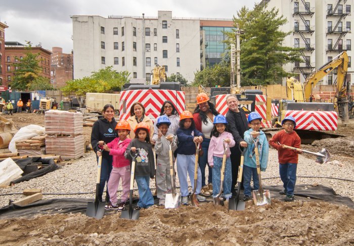 Kids and staff posing for groundbreaking dig