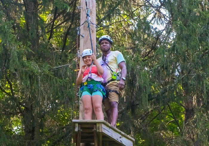 Young girl attempting rope course at Wagon Road Camp