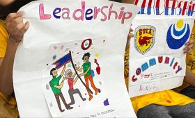 Salomé Ureña Leadership Academy students holding up signs