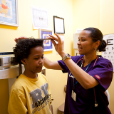 Student getting height measured at doctor's office