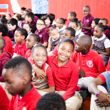 Kids sitting in a gym