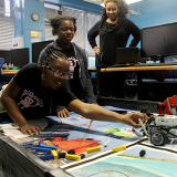 Young girls working on robots