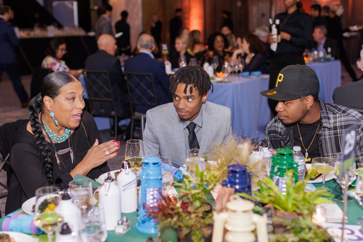 Brenda Triplett, Errik Grubbing, and Denzel "Zel" Rodriguez engaged in conversation.