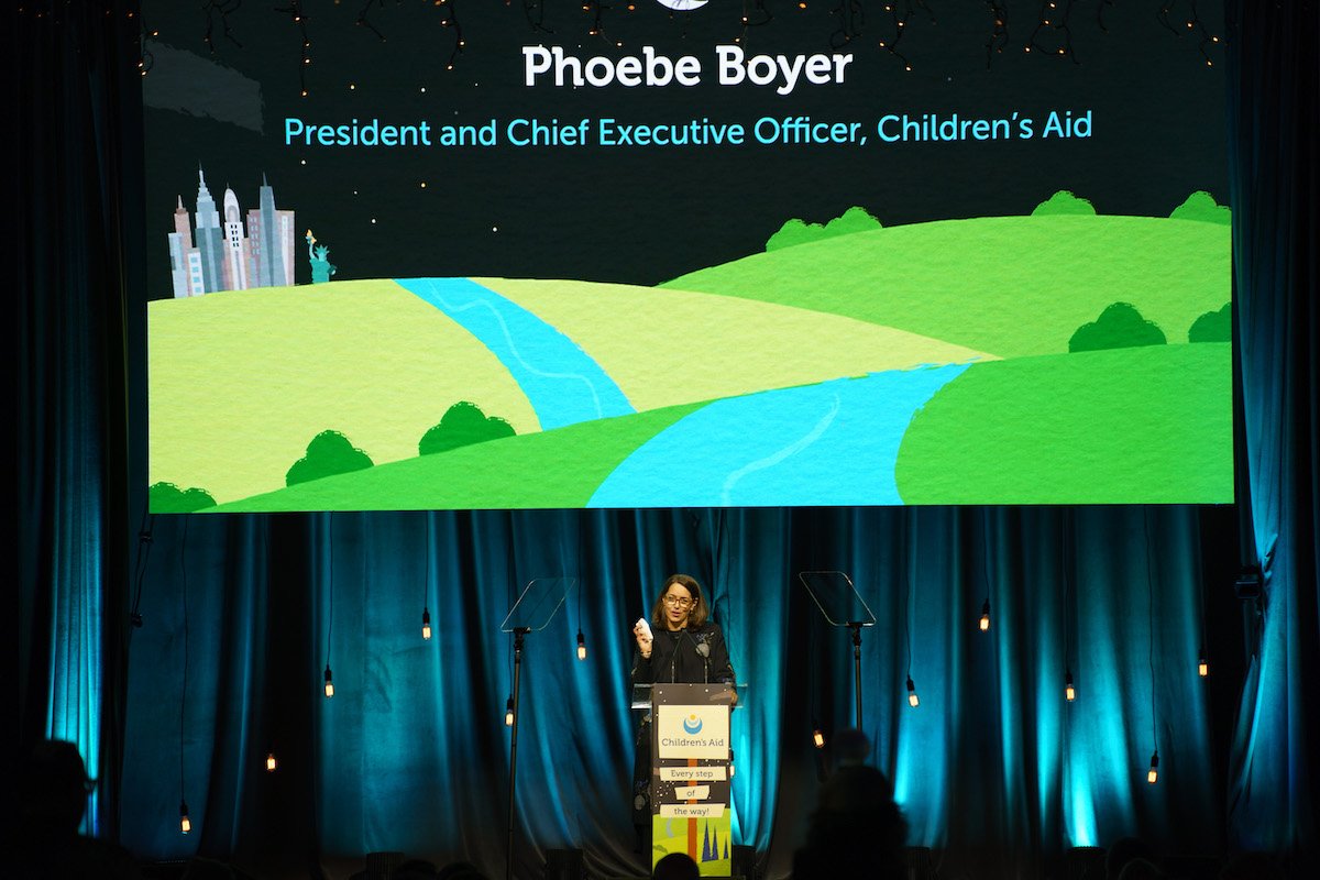 President and CEO Phoebe Boyer sharing her welcome remarks and setting the stage.